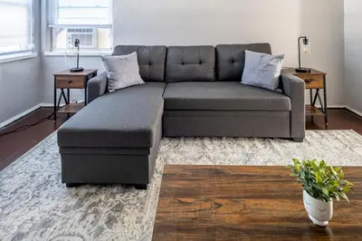 a living room with a gray couch in a room at Relaxed 2BR Apt in Moraine with Office Space and Washer & Dryer in Moraine