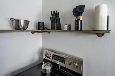 a shelf above a stove in a kitchen at Relaxed 2BR Apt in Moraine with Office Space and Washer & Dryer in Moraine