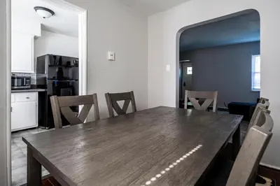 a dining room with a wooden table and chairs at Relaxed 2BR Apt in Moraine with Office Space and Washer & Dryer in Moraine