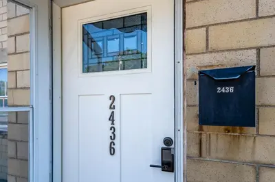 a white front door with a address sign on it at Relaxed 2BR Apt in Moraine with Office Space and Washer & Dryer in Moraine