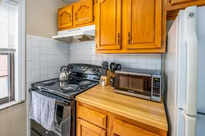 a kitchen with a stove and a microwave at Paws & Peace Cozy 1BR Ground Flr Gem in Dayton in Dayton