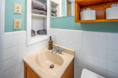 a bathroom with a sink and a mirror at Paws & Peace Cozy 1BR Ground Flr Gem in Dayton in Dayton