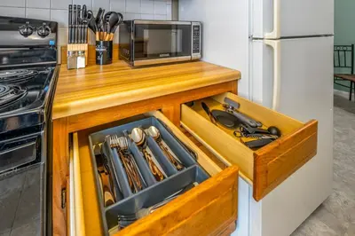 a wooden drawer in a kitchen next to a microwave at Paws & Peace Cozy 1BR Ground Flr Gem in Dayton in Dayton
