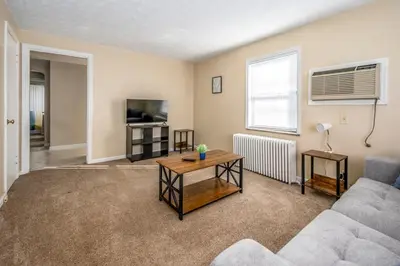 a living room with a couch and a table at Paws & Peace Cozy 1BR Ground Flr Gem in Dayton in Dayton