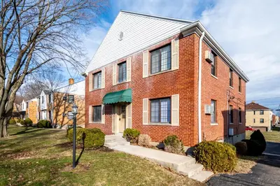 a red brick house with a white roof at Paws & Peace Cozy 1BR Ground Flr Gem in Dayton in Dayton