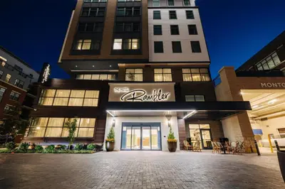 a building with a sign for a boutique at The Hotel Rambler Montgomery, Tapestry Collection By Hilton