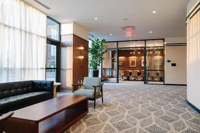 a lobby with a couch and a table and chairs at The Hotel Rambler Montgomery, Tapestry Collection By Hilton