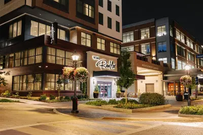 a store front of a building at night at The Hotel Rambler Montgomery, Tapestry Collection By Hilton