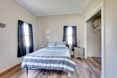 a bedroom with a bed with a blue and white blanket at Charming and Convenient Home in Butler