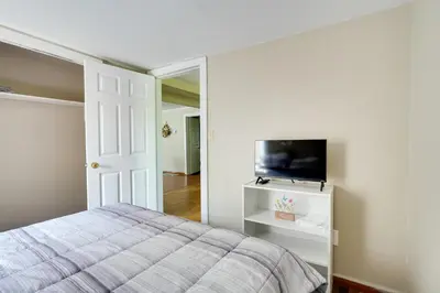 a bedroom with a bed and a flat screen tv at Charming and Convenient Home in Butler