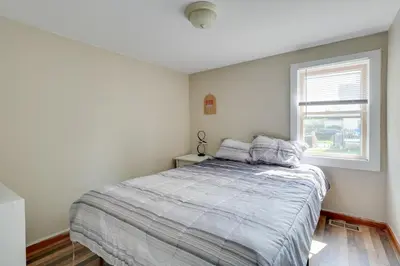a bedroom with a bed and a window at Charming and Convenient Home in Butler