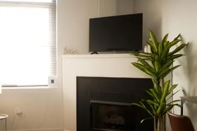 a fireplace with a flat screen tv on top of it at Charming 2 Bedroom Loft in Cleveland