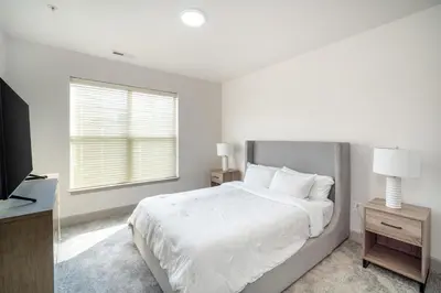 a white bedroom with a large bed and a window at Landing Spectacular 2BD Clubhouse Pool in Cincinnati