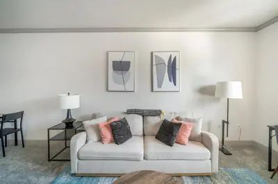 a living room with a white couch with pillows at Landing Spectacular 2BD Clubhouse Pool in Cincinnati