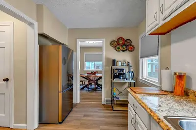 a kitchen with a stainless steel refrigerator and a dining room at South Euclid 3BR Cozy Winter Escape in South Euclid