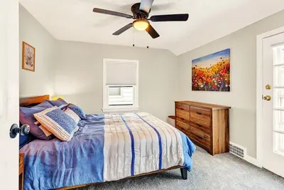 a bedroom with a bed and a ceiling fan at South Euclid 3BR Cozy Winter Escape in South Euclid