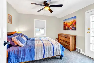 a bedroom with a bed and a ceiling fan at South Euclid 3BR Cozy Winter Escape in South Euclid