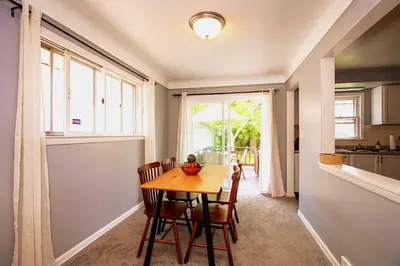 a dining room with a table and chairs and a window at Maple Heights 3BR Cozy and Spacious in Maple Heights