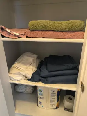 a shelf with towels and other items in a closet at Maple Heights 3BR Cozy and Spacious in Maple Heights