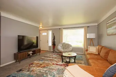 a living room with a couch and a flat screen tv at Maple Heights 3BR Cozy and Spacious in Maple Heights
