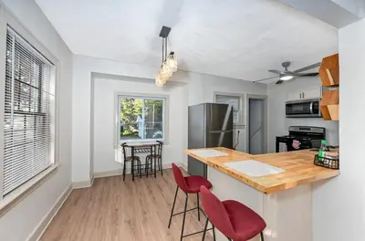 a kitchen with a counter and two red chairs at Cozy 2BR Lyndhurst Retreat in Lyndhurst