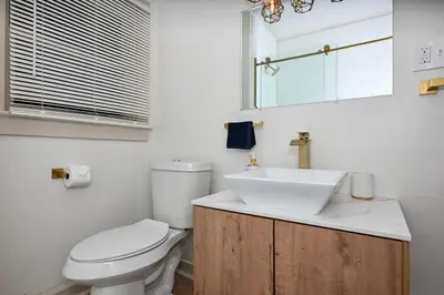 a bathroom with a white toilet and a sink at Cozy 2BR Lyndhurst Retreat in Lyndhurst