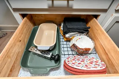 a drawer with a remote control and other items in it at Cozy 2BR Lyndhurst Retreat in Lyndhurst