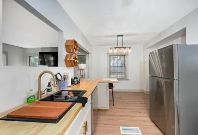 a kitchen with a stainless steel refrigerator and wooden counter top at Cozy 2BR Lyndhurst Retreat in Lyndhurst