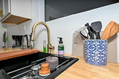 a kitchen counter with a sink and a knife block at Cozy 2BR Lyndhurst Retreat in Lyndhurst