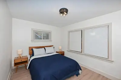 a bedroom with a blue bed and a window at Cozy 2BR Lyndhurst Retreat in Lyndhurst