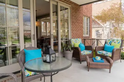 a patio with chairs and a table on a porch at Bexley Bed and Breakfast in Columbus