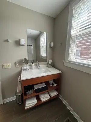 a bathroom with a sink and a mirror at Bexley Bed and Breakfast in Columbus
