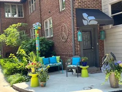 a patio with chairs and flowers in front of a house at Bexley Bed and Breakfast in Columbus
