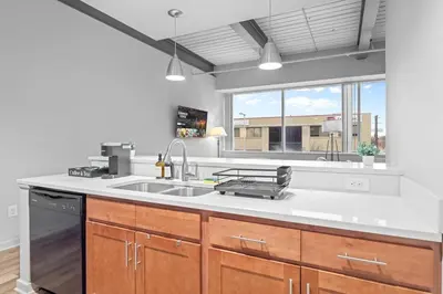 a kitchen with a sink and a large window at Spacious 2 BD Apt l Downtown Cleveland l Free Parking in Cleveland