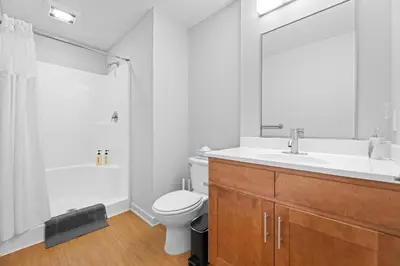 a bathroom with a sink and a toilet and a shower at Spacious 2 BD Apt l Downtown Cleveland l Free Parking in Cleveland