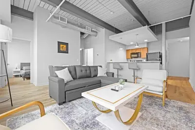a living room with a couch and a table at Spacious 2 BD Apt l Downtown Cleveland l Free Parking in Cleveland