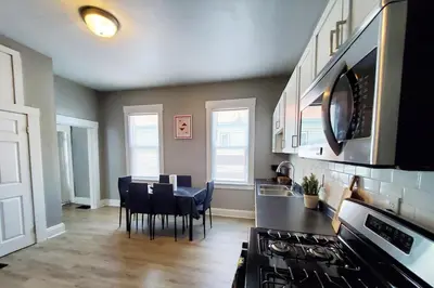 a kitchen and dining room with a stove and a table at Cozy 2BR, Near Top attractions in Covington