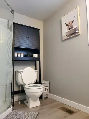 a bathroom with a toilet and a picture of a deer on the wall at Cozy 2BR, Near Top attractions in Covington