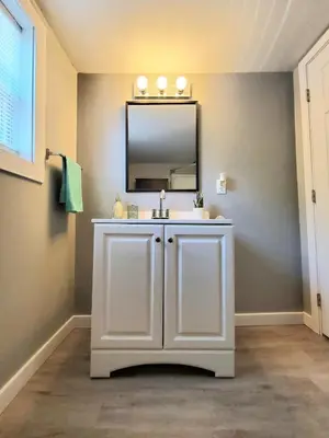 a bathroom with a white sink and a mirror at Cozy 2BR, Near Top attractions in Covington