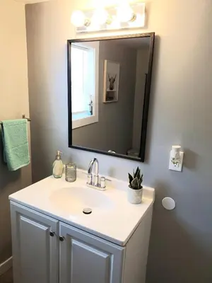 a bathroom with a sink and a mirror at Cozy 2BR, Near Top attractions in Covington