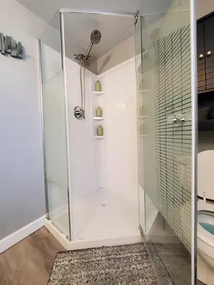 a shower with a glass door in a bathroom at Cozy 2BR, Near Top attractions in Covington