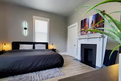 a bedroom with a bed and a fireplace at Cozy 2BR, Near Top attractions in Covington