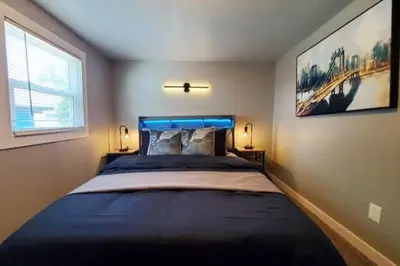 a bedroom with a large bed and a window at Cozy 2BR, Near Top attractions in Covington