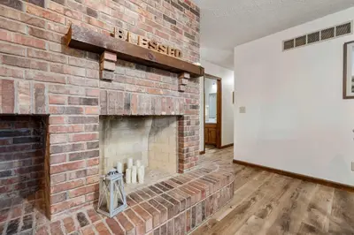 a brick fireplace in a living room with a brick wall at The Family Nook - Home for 8 in Hamilton