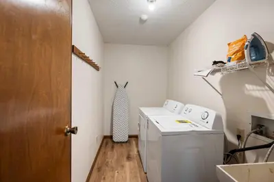 a small laundry room with a washer and dryer at The Family Nook - Home for 8 in Hamilton