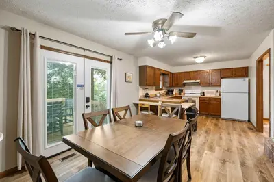 a kitchen and dining room with a table and chairs at The Family Nook - Home for 8 in Hamilton