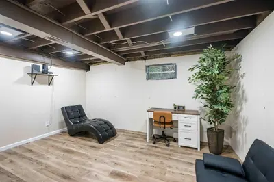an office with a desk and a chair and a plant at The Family Nook - Home for 8 in Hamilton