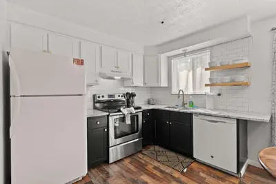 a kitchen with white cabinets and a white refrigerator at The StayBerry - Stay for 6 in Columbus
