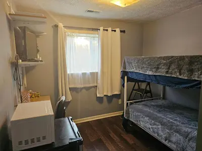 a bedroom with two bunk beds and a window at Navarre Guest Rooms in Columbus