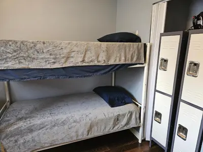 two bunk beds in a room with blue pillows at Navarre Guest Rooms in Columbus